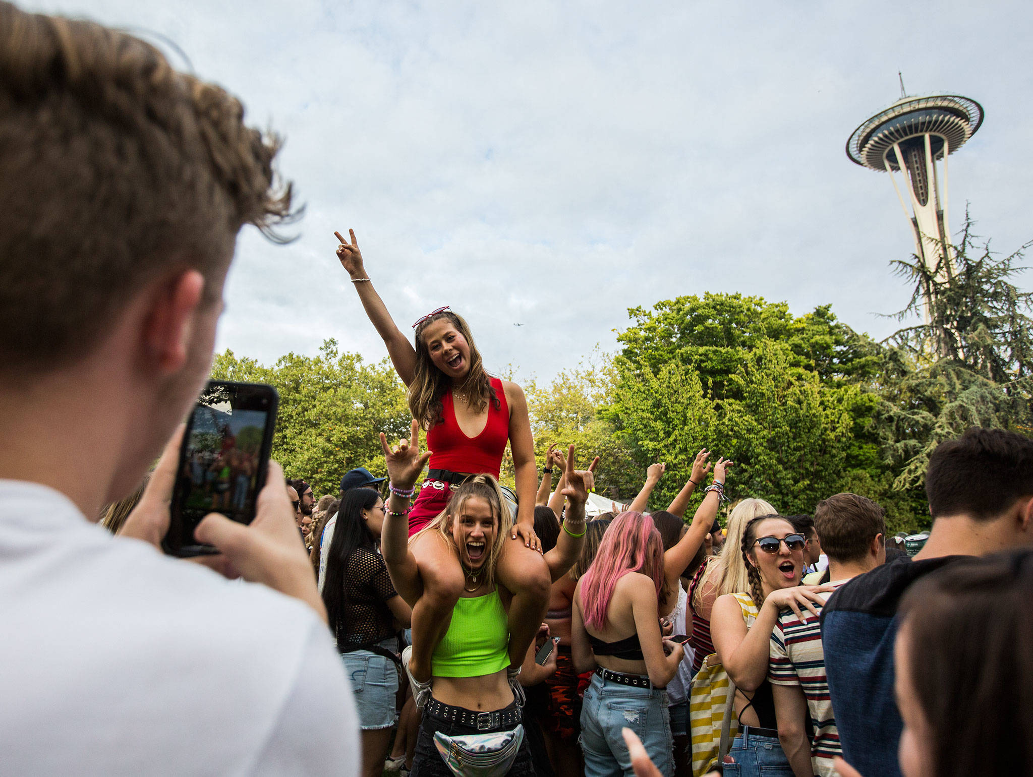 Two girls have their photo taken during Sols performance at Bumbershoot Music & Arts Festival on Friday, Aug. 30, 2019 in Seattle, Wash. (Olivia Vanni / The Herald)